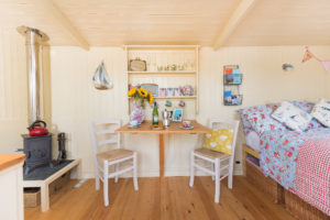 Dining table and chairs below the pretty dresser in Hut-next-the-Sea, North Norfolk.